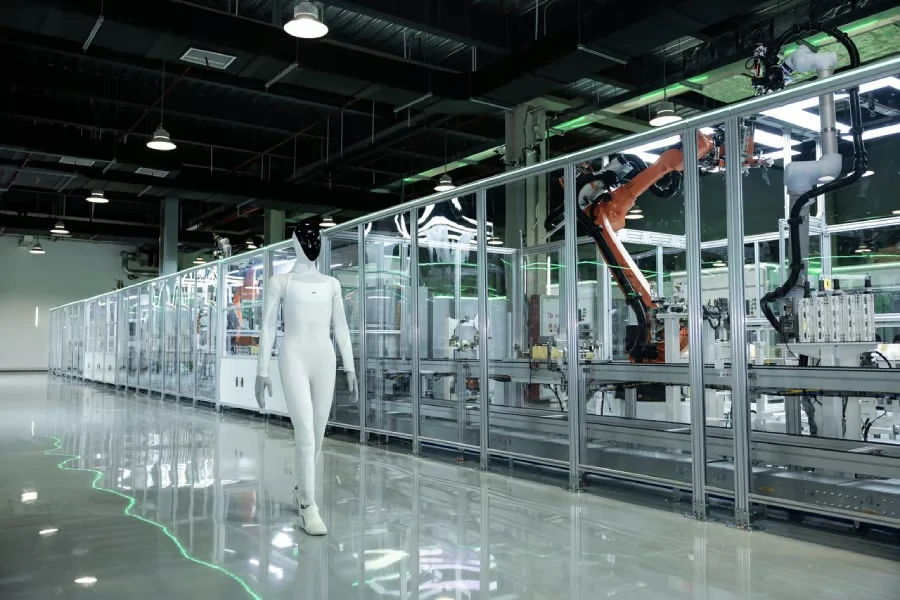 XPENG’s IRON humanoid robot walks beside the company’s newly commissioned automated production line in Guangzhou.